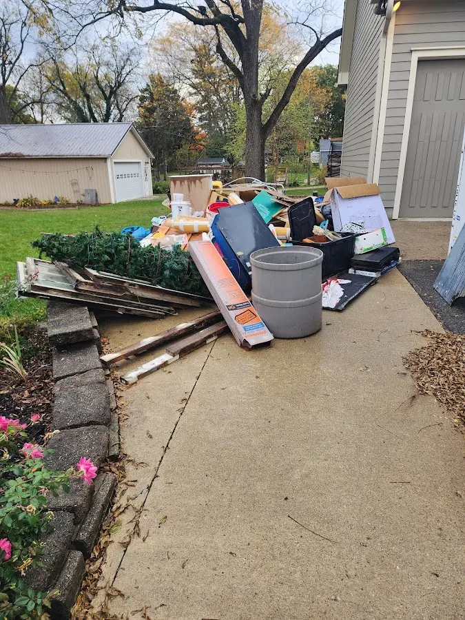 Dumpster being loaded with debris for 3 Yard Dumpster Rental in Madisonville